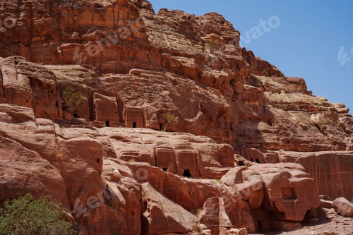 Preview: Ruins of the ancient city of Petra against a blue sky on a sunny day
