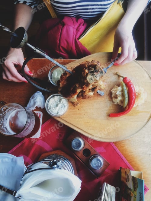 Preview: Woman with Pork Knuckle and Beer at Restaurant