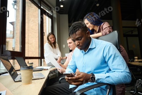 Preview: Man chatting with friends or playing games during project discussion