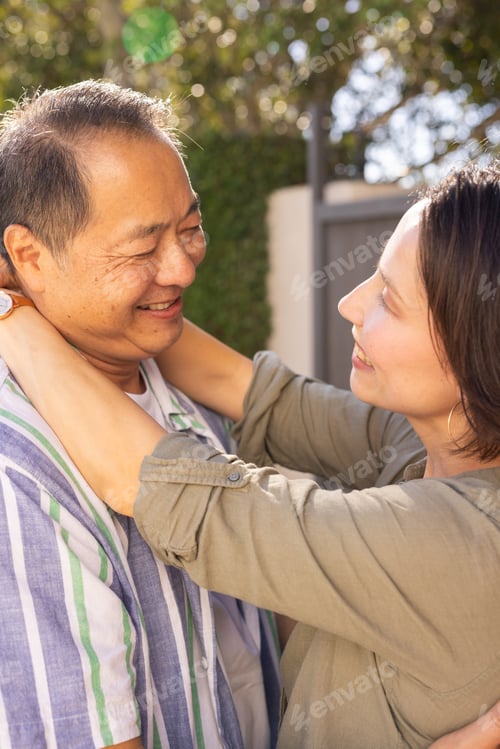 Preview: Embracing outdoors, smiling multiracial middle-aged couple enjoying quality time together