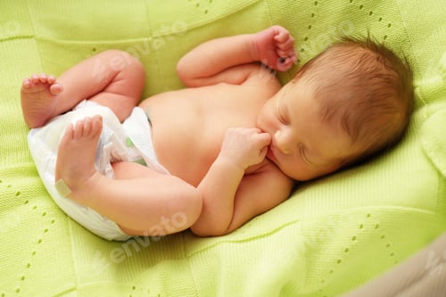 Preview: Sleeping Infant Lying on Soft Green Blanket
