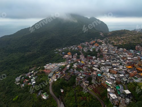 Preview: Aerial view of Jiufen hillside town and lush green mountains in Taiwan.