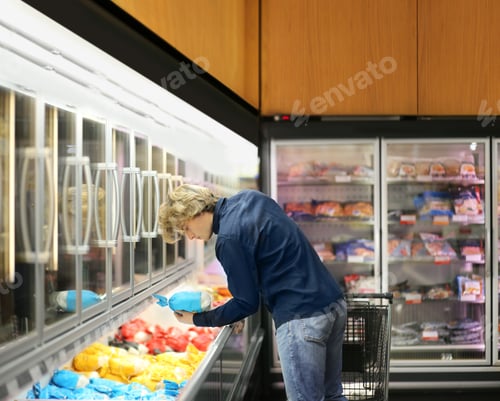Preview: Man Choosing Frozen Food From A Supermarket Freezer