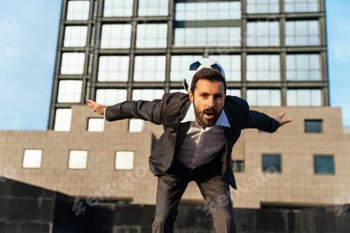Preview: Businessman playing with a soccer ball and making freestyle tricks