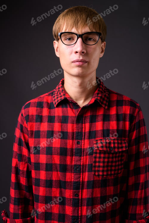 Preview: Young handsome man with blond hair against gray background