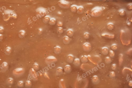 Preview: Brown milk chocolate bar with nuts background.