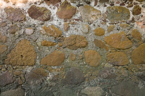 Preview: gray wall surface of old stones with plaster in cracks.