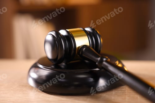 Preview: Judge's gavel on wooden table against blurred background, closeup