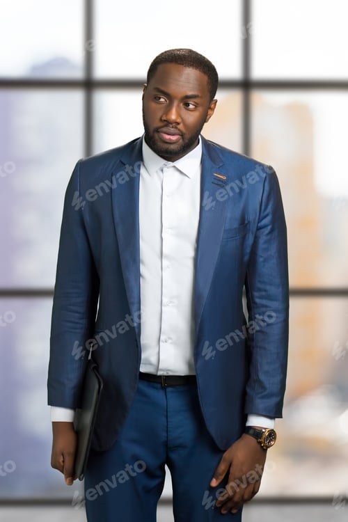 Preview: Thoughtful businessman on blurred background.