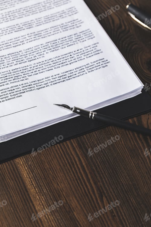 Preview: juridical contract on wooden table with pen, law concept