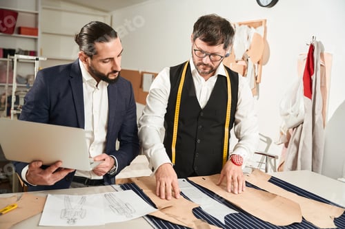 Preview: Couturiers working on new collection in workshop