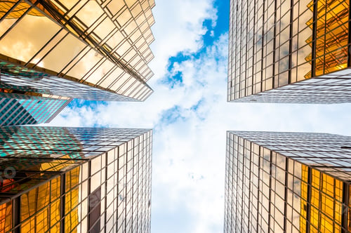 Preview: Golden skyscrapper building with blue sky in Hong Kong. Windows glass of modern office