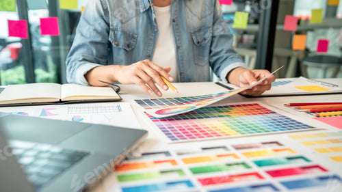 Preview: Young creative graphic designer working on color selection and drawing on graphics tablet