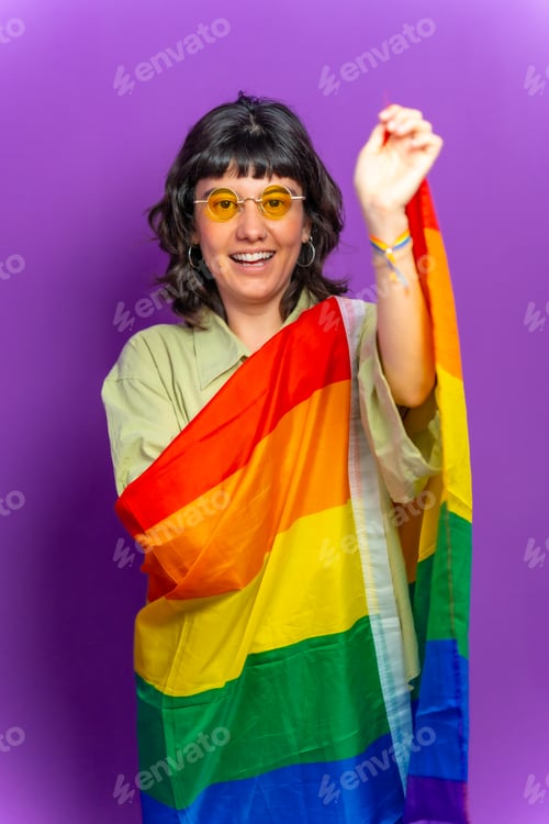 Preview: Happy lesbian woman covered with lgbt rainbow flag