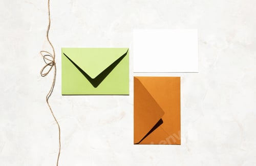 Preview: Colorful mail envelopes and empty white paper card and twine with bow