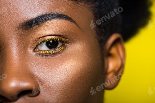 Preview: Cropped view of beautiful african american looking at camera on yellow