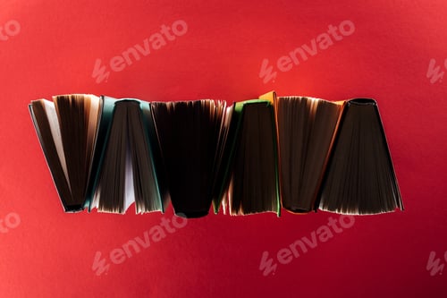 Preview: Top view of hardcover books on red surface