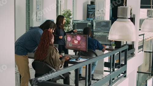 Preview: Diverse group of app developers working with hacked computer