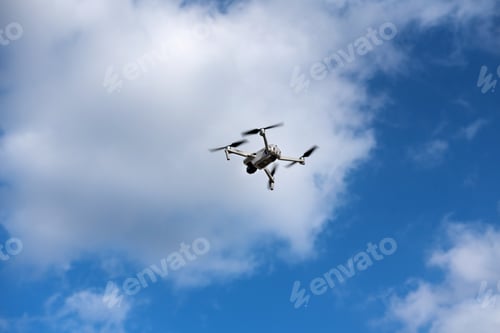 Preview: a drone takes pictures from the sky, drone reconnaissance, on a blue sky background