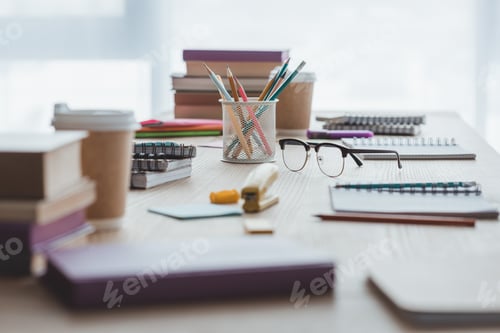 Preview: selective focus of educational copybooks, books, pencils and eyeglasses