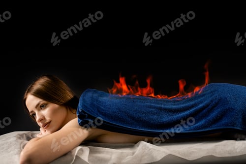 Preview: Relaxing fire back massage session. Woman enjoys Chinese Huo Liao spa procedure.