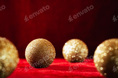 Preview: Gold christmas balls on red background