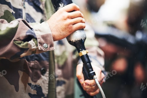 Preview: Closeup paintball gun, hands and man with camouflage clothes, ready and start for outdoor combat ga