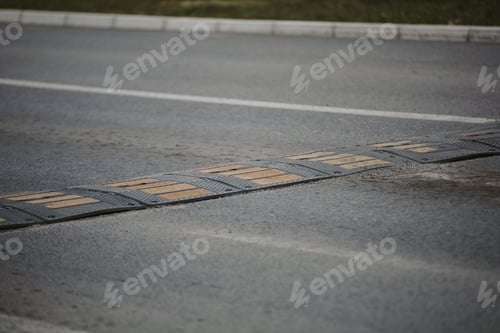 Preview: Shallow focus shot of an artificial barrier sign with yellow and white lines.