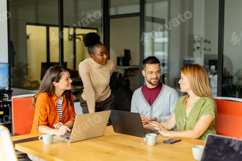 Preview: Young multiethnic startup team working in the modern office