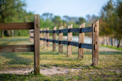 Preview: Wooden fence barrier at farm grounds for cattle and territory protection