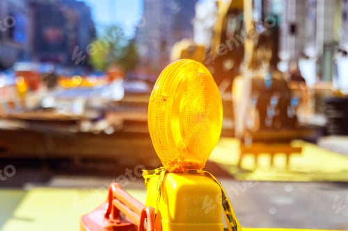 Preview: Close up of yellow warning orange construction light on barricade intended to warn a construction