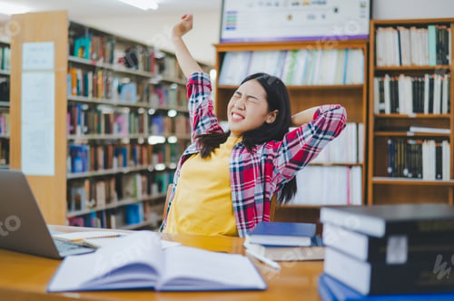 Preview: Students are relaxing after working on their laptops and searching for books