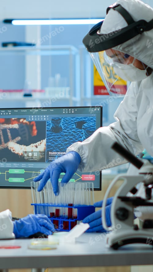 Preview: Doctor with coverall working with blood samples