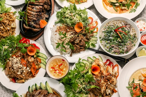 Preview: assortment of mixed traditional vietnamese food dishes on buffet table