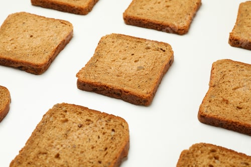 Preview: Flat lay with dark bread slices on white background