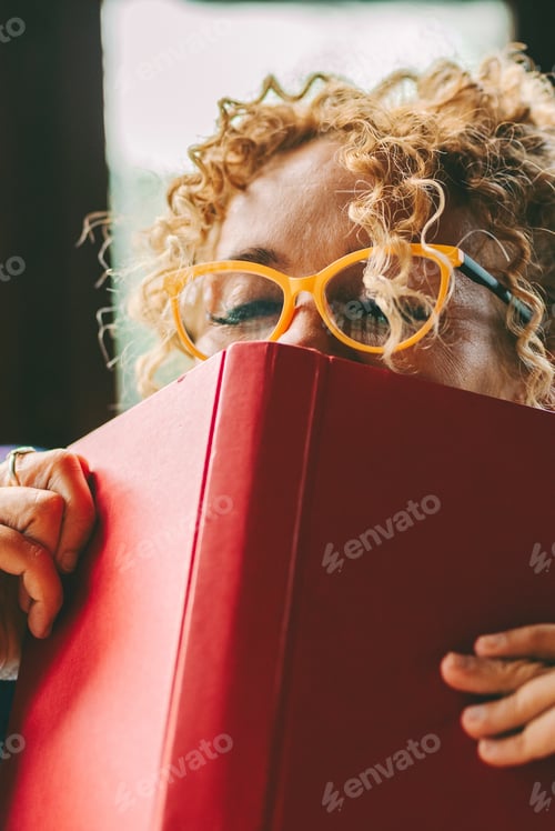 Preview: Woman relax and pleasure expression about reading a book novel alone at home. Happiness