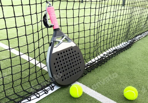 Preview: paddle tennis racket and balls on court