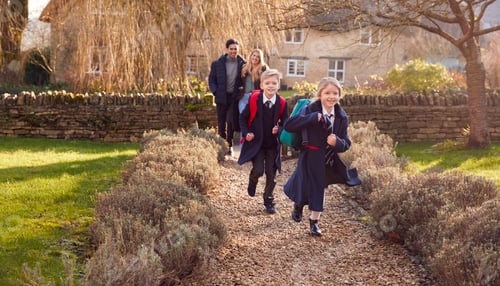 Preview: Parents Returning Home From School With Children Wearing School Uniform Running Down Path