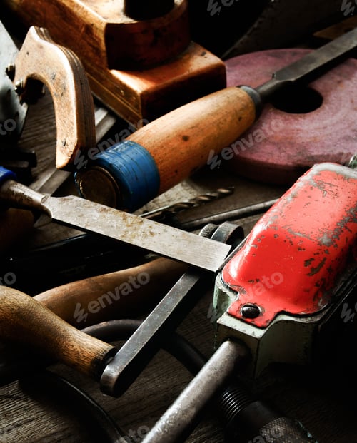 Preview: Many old working tools ( ruler, drill, chisel and others) on a wooden background.