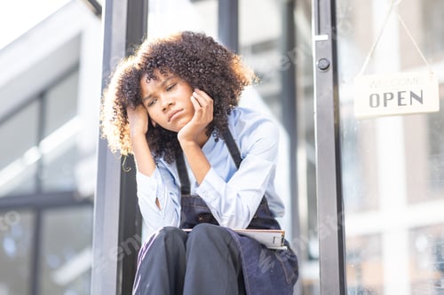 Preview: Portrait of Young african american small business owner woman wearing apron and looking away to you
