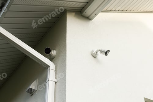 Preview: Security video cameras on white facade walls