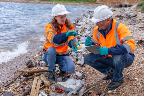 Preview: Two environmental workers in safety gear analyzing