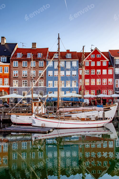 Preview: COPENHAGEN, DENMARK - MAY 6, 2018: boats and beautiful historical buildings reflected in calm water,