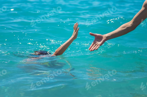Outstretched Hand Reaches for Person in Ocean Water