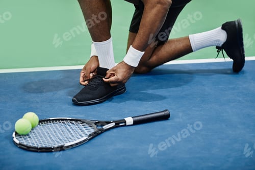 Preview: Tennis Player Tying Sports Shoes
