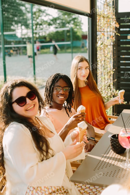 Preview: Young friends are eating ice cream at a bar