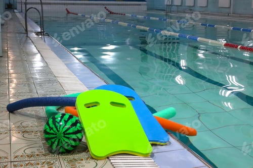 Preview: still life of water sports equipment:kickboards, swimming goggles, pull buoys, aquapoles, ball