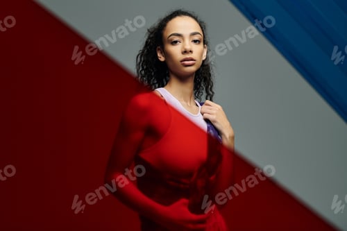 Preview: African american athlete posing in red light