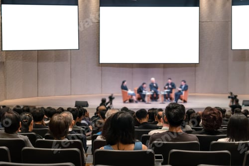 Preview: Rear view of Audience over the speakers on the stage in the conference hall or seminar meeting