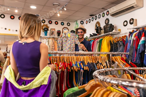 Preview: Man choosing shirt in shop with girlfriend